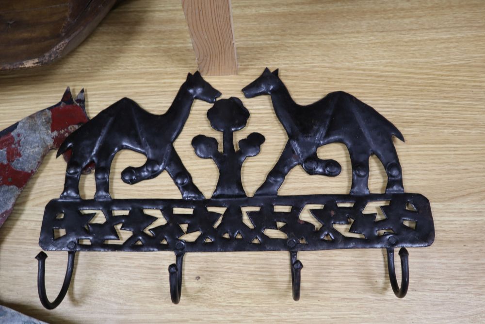 A 19th century sycamore grain shovel, 98cm., a beech wall shelf and two painted sheet metal ornaments